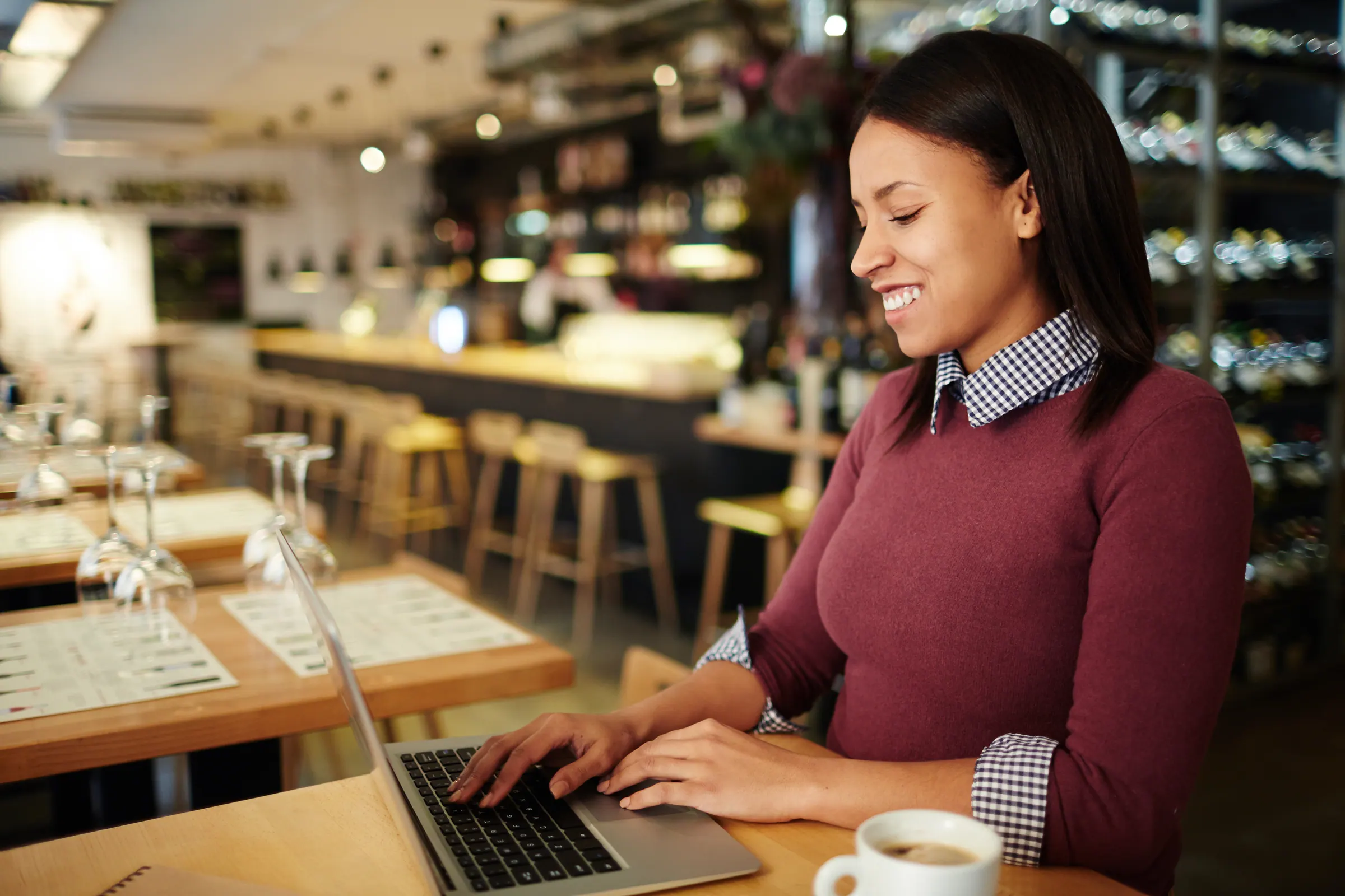 A person taking a thoughtful coffee break in a sunlit workspace — calm, no pressure.