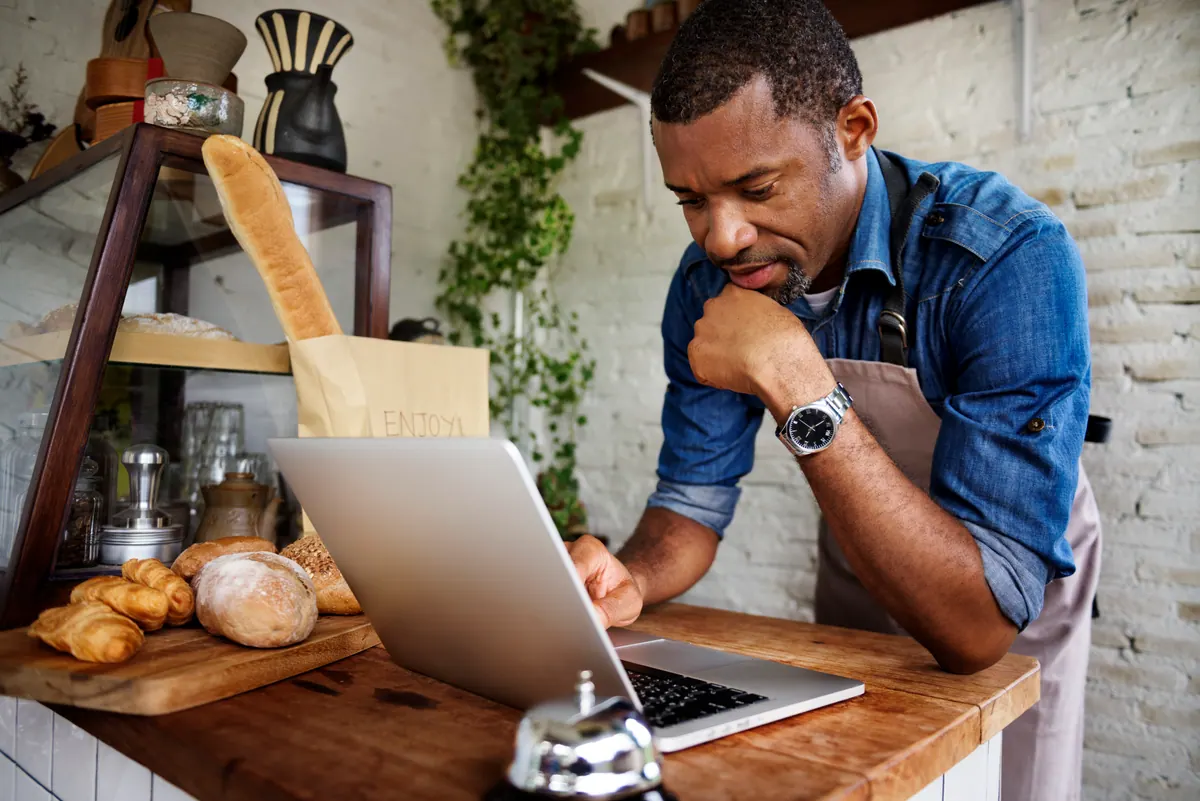 An owner handling work by laptop — why we run on written requests, not standing phone calls.
