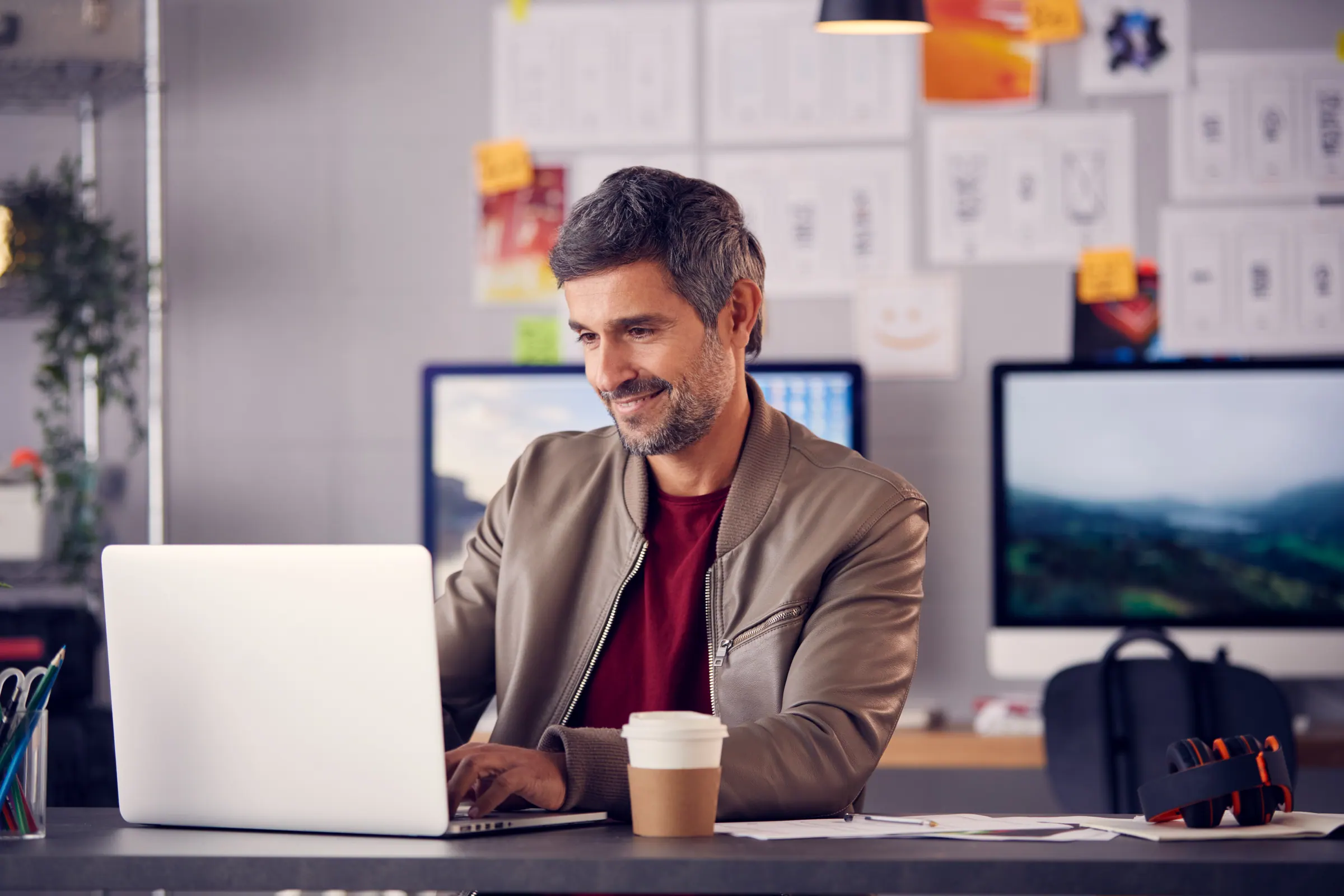 An operator working at a studio desk — one team running the whole web presence.