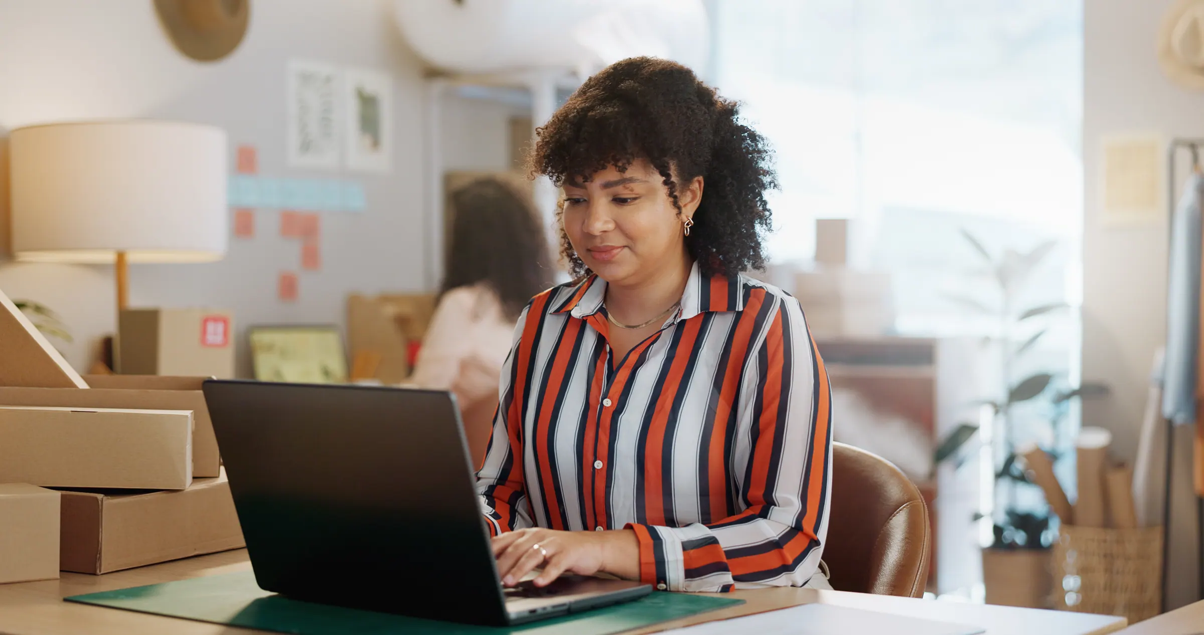 A local small-business owner at a laptop — the kind of business whose website is one homepage and little else.