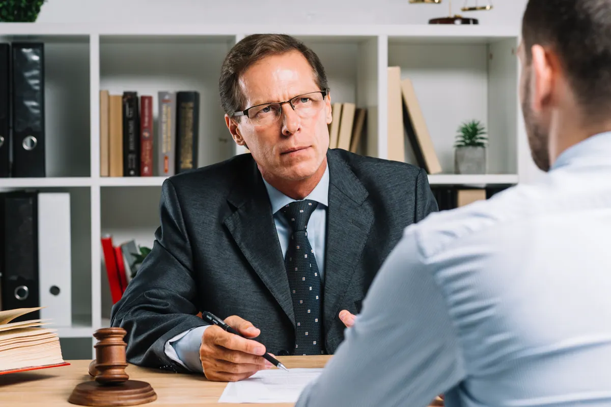 An attorney meeting with clients — the five pages a small law firm needs to rank locally.
