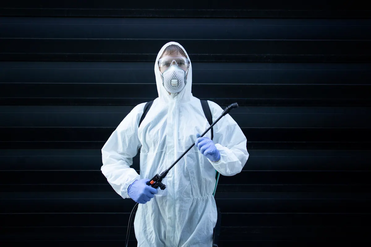 A professional exterminator with pest-control equipment — local SEO for family-run operators.